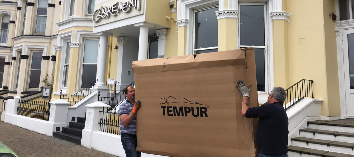 Delivery staff at Millichap's carrying a Tempur bed on the Isle of Man